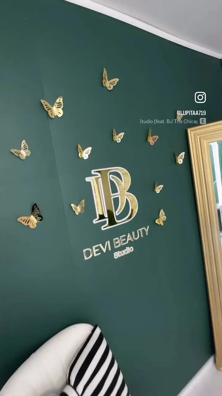 The DeVi Beauty Studio sign wall, hand set in gold with butterflies